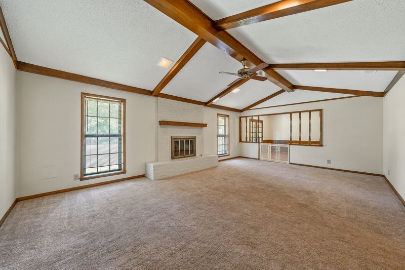 23'×15' family room with a vaulted, beamed ceiling and gas fireplace