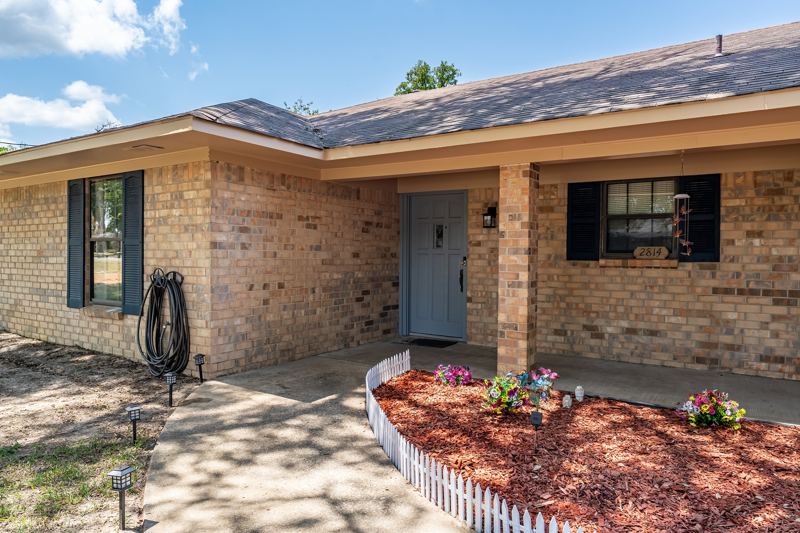 Covered front porch, with shutters on the front windows